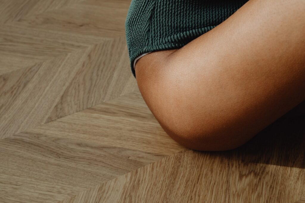 Leg and Hip of a Girl Sitting on the Floor